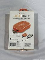 Photo of the back of the box showing key features, ports (micro USB, USB-C, USB output), and charger cable compatibility details.