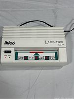 Top-down photo displaying the white Ibico ML-9 laminator with visible control panel and branding.