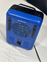 Front angled view of blue Mastercraft Milkhouse Utility Heater showing ventilation grill, controls, and handle on top.