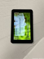 Front view of Nextbook NX007HD tablet powered on showing system message on screen.