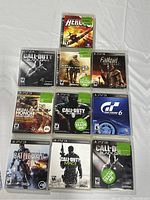 Photo showing all ten PS3 game cases arranged on a flat surface, titles and cover art clearly visible.