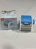 View of the Create-A-Sticker Mini device with original box showing product.
