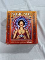 Front of the original Nokia 3300 box with vintage artwork featuring a woman holding the phone.
