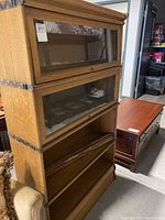 Front view of four stacking sections showing two glass doors on upper tiers and open lower tiers