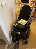 Front view of wheelchair showing seat, base and footrests