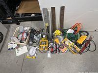 Overview of lot showing all assorted tools including levels, drill bits, extension cord, and more