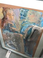 Full view of framed artwork on floor with lot tag visible