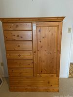 Front view of entire dresser showing drawer layout and cabinet door