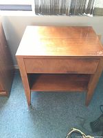 Front view of one night stand showing drawer and open shelf