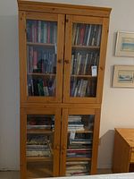Front view of pine bookcase loaded with books