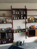 Overall front view of entire teak modular wall unit with shelves and compartments mounted.