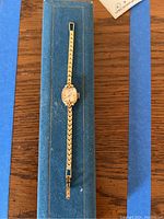 Full view of watch in blue presentation case