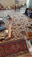 Full view of rug laid on wood floor with scattered items