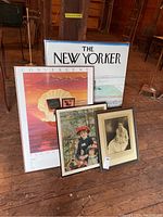 Photo showing all four framed artworks together on wooden floor in barn setting.