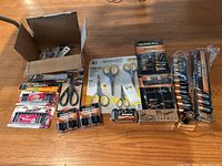 Full lot overview showing batteries and five pairs of scissors, some in original packaging.