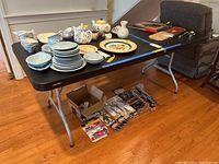 Full overview photo of the Lifetime folding table with various items on top, showing table size and appearance.