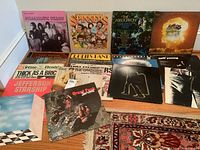 Overview of ten album covers laid out on floor, showing a mix of classic rock LPs