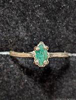 Front view of the sterling silver ring with an emerald gemstone showing the stone and band detail.