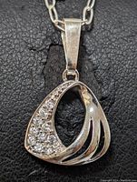 Close-up front view of the sterling silver pendant showing the rhinestone detail and abstract cut-out design.