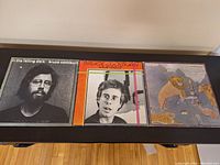 Photo showing all three LP album covers side by side on a table