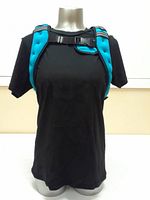 Front view of the blue weighted vest worn on a mannequin with black T-shirt, showing adjustable chest buckle straps
