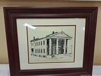 Framed black and white pen and ink drawing of Napanee Town Hall, showing front and side facades with classical columns.