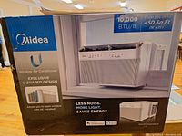 Front of sealed retail box showing Midea branding, image of window air conditioner, 10,000 BTU/h and room size coverage up to 450 sq ft
