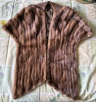 Full view of the light brown mink fur shawl or cape laid flat showing shape and overall condition