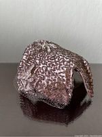 Front side close-up showing detailed bead work and netted veil on pink fabric base.