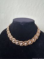 Front view of the vintage Napier gold-tone necklace with faux pearls displayed on black velvet bust showing the chain and pearl arrangement.