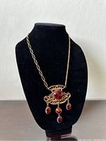 Front view of necklace displayed on black bust