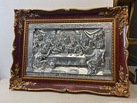 Full frontal photo of the framed pewter relief artwork depicting The Last Supper with ornate wooden frame and gold accents.