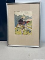 Full view of the framed watercolor painting showing a farmhouse and mountains.