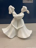 Front view of Royal Doulton white porcelain dancing figurine.