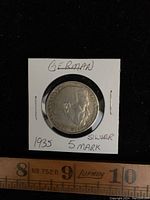 Obverse side of the 1935 German 5 Mark silver coin showing the profile of a man with surrounding inscriptions.