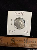 Obverse of the 1947 Canada nickel coin showing King George VI portrait and inscriptions.