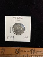 Obverse side of the 1947 Canada 5 cents nickel coin featuring King George VI portrait.