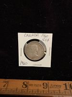 Obverse side of the 1960 Canadian fifty cent coin showing Queen Elizabeth II and surrounding text.