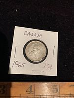 Front side of 1965 Canada quarter showing Queen Elizabeth II profile