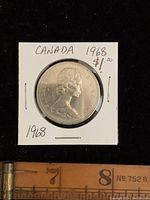 Obverse side of the 1968 Canadian one dollar coin showing Queen Elizabeth II's portrait with the year 1968.