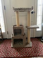 Front view of the cat tree showcasing two box enclosures, sisal posts, and climbing platforms.