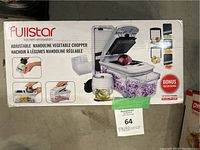 Front view of the Fullstar kitchen innovation adjustable mandoline vegetable chopper box showing the main product image with the tool and container and example uses for slicing, grating, and chopping vegetables.