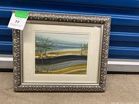 Framed abstract landscape painting with silver ornate frame showing full artwork.