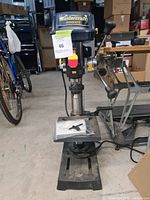 Front view of Mastercraft Hawkeye bench drill press showing base, column, and motor housing with label.