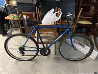 Full side view of the blue Vancouver bicycle with 24-inch tires, showing frame, seat, wheels, and handlebars.