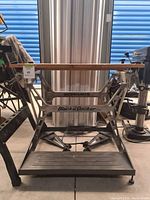 Side view of Black & Decker Workmate workbench showing metal frame with branding and base platform.