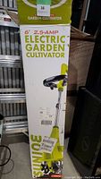 Front of the original box showing product name, 6 inch, 2.5 AMP Electric Garden Cultivator with picture of the tool.