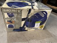 Photo of the Euro-Pro X vacuum cleaner in original box showing product image and features.