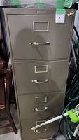 Front view of the 4-drawer filing cabinet showing handles and label holders on the drawer fronts.