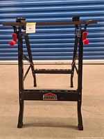 Front view of foldable workbench showing JOBMATE branding and red adjustment handles.